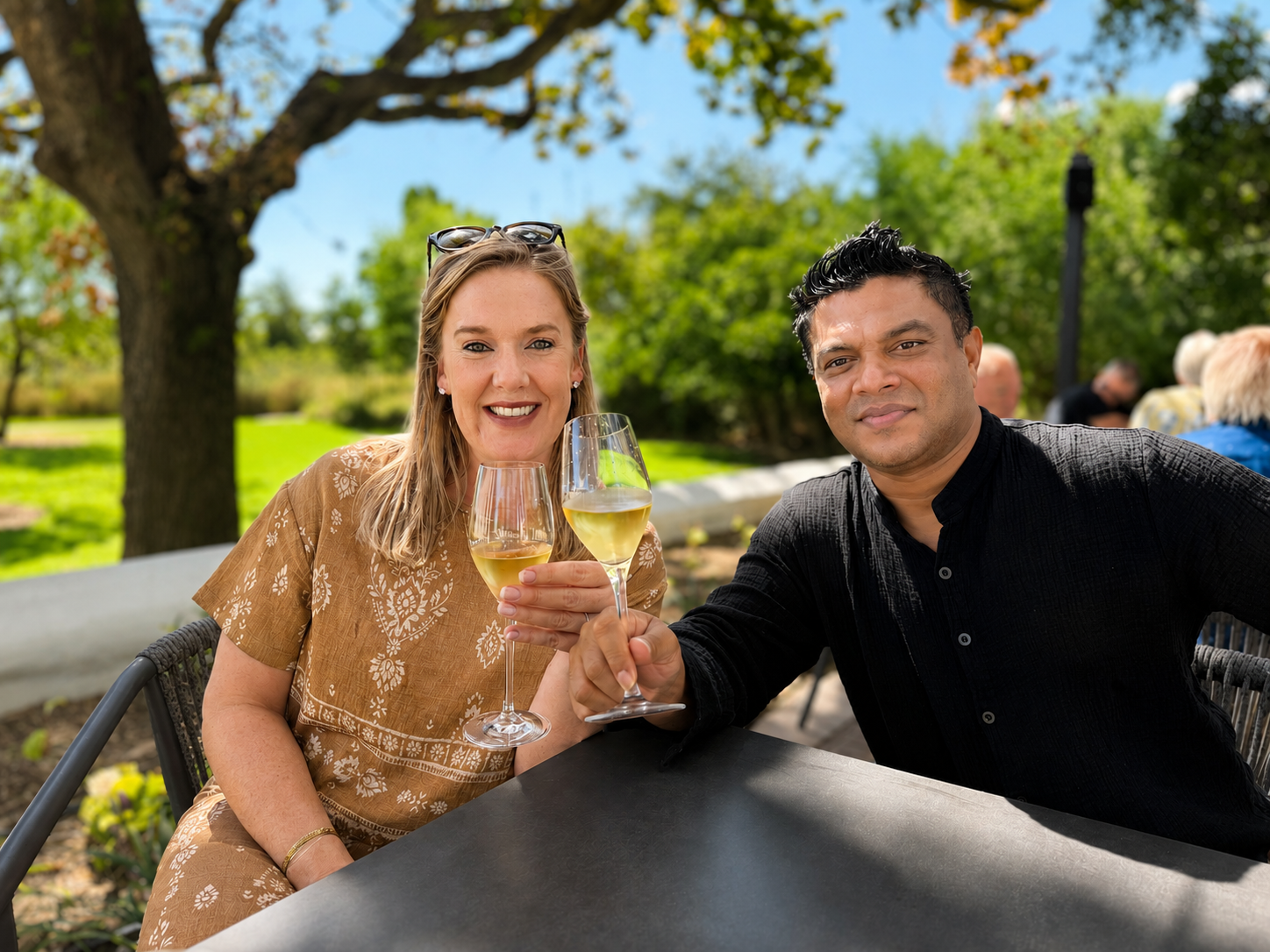 Nadine and Sobah toasting with white wine at the estate